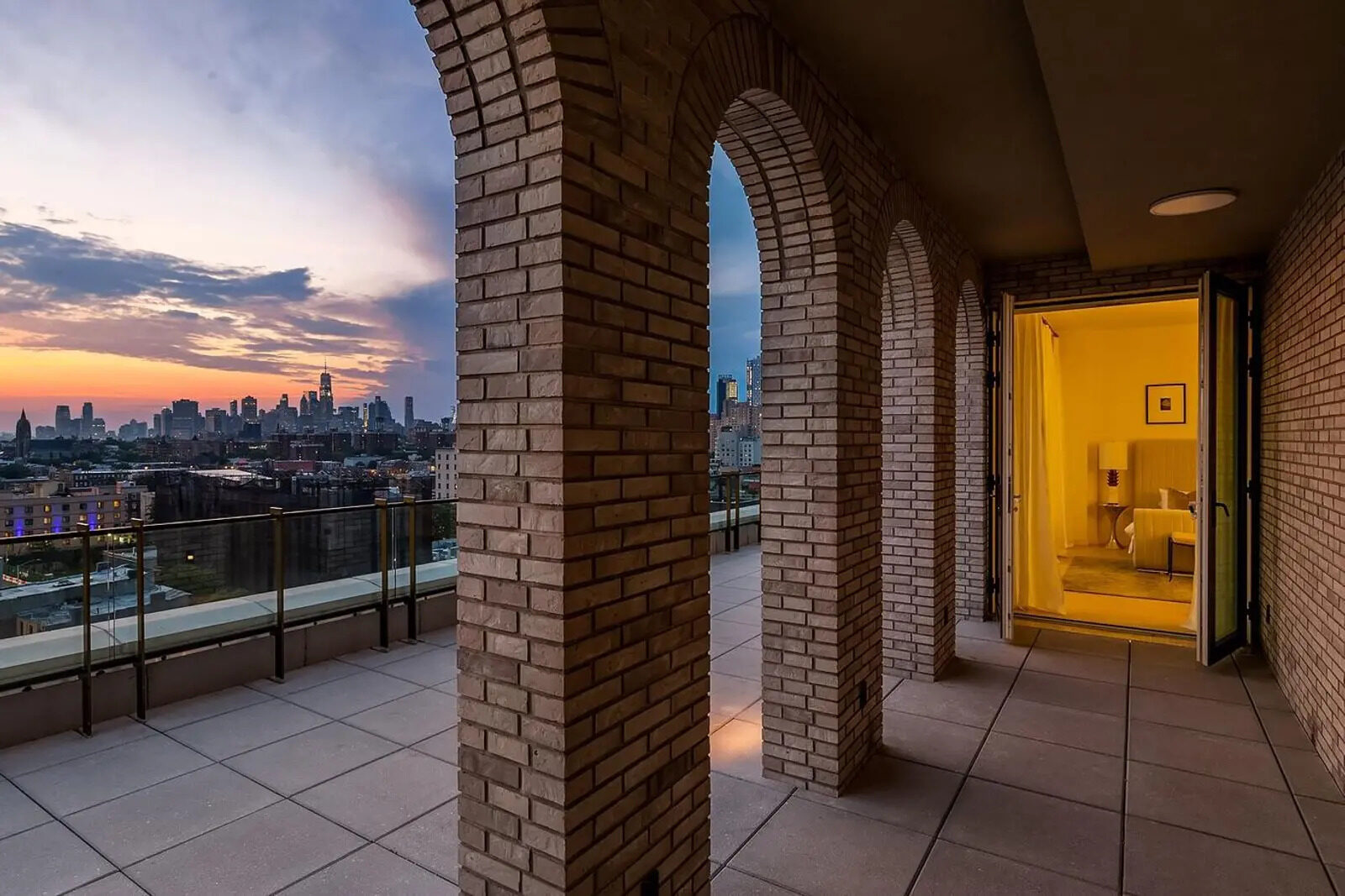Arched loggia with the Manhattan skyline at dusk