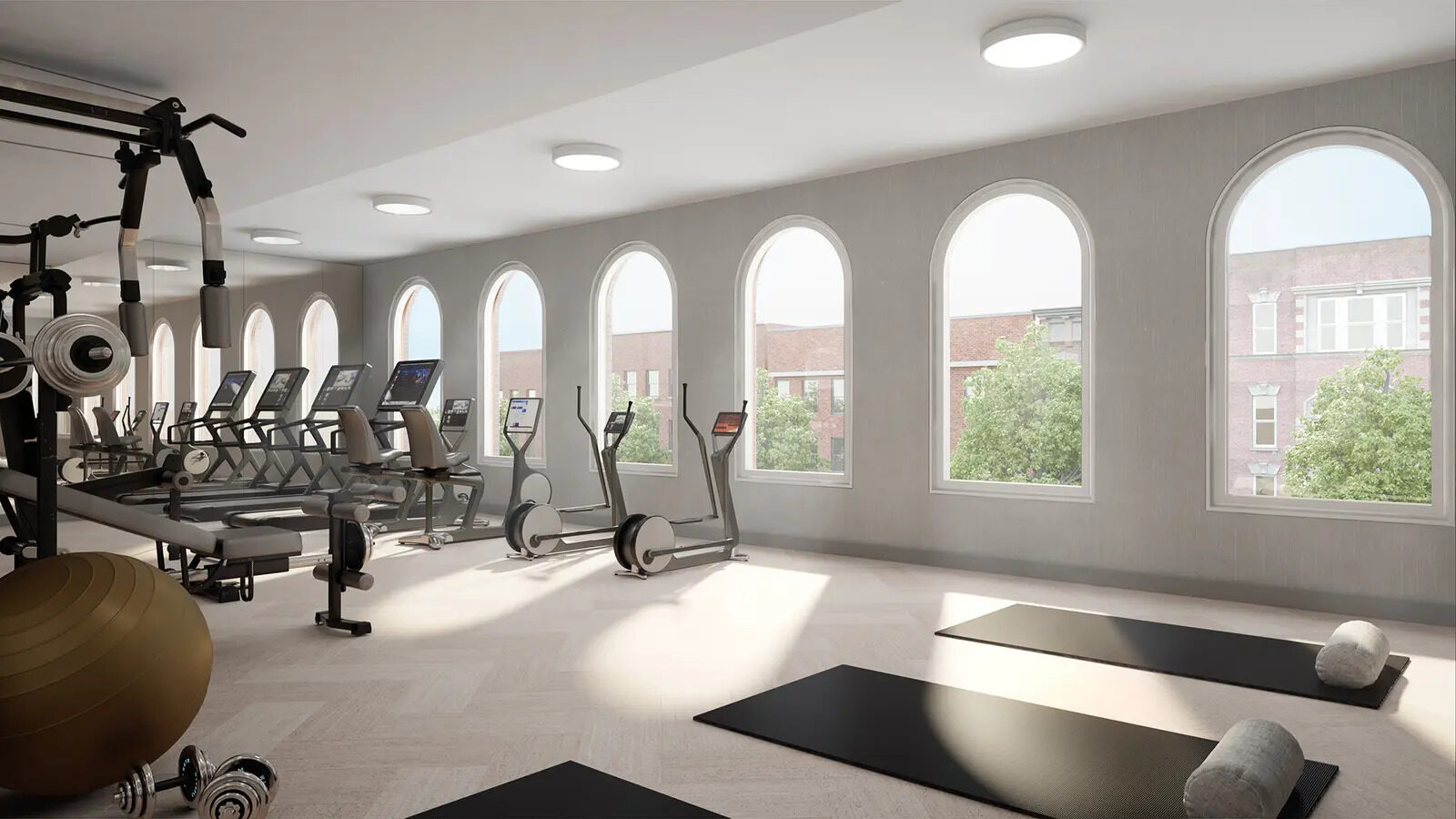 Fitness center beneath arched windows